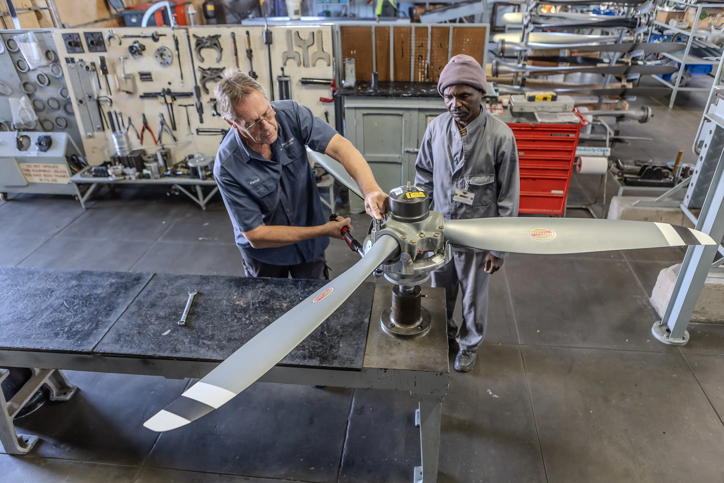 Technicians working on a propeller in the specialist workshop